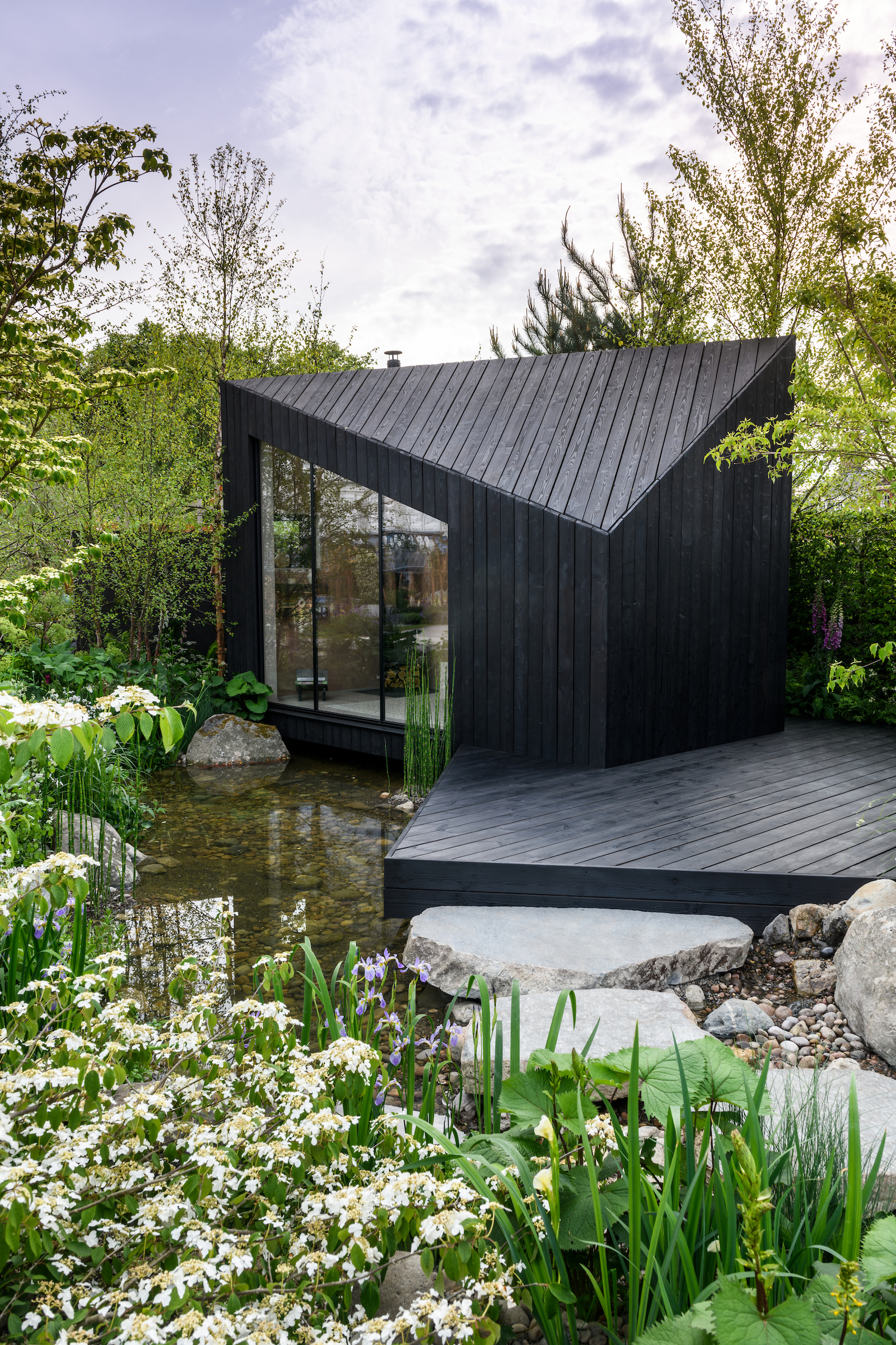 A koto cabin with decking and calming water feature